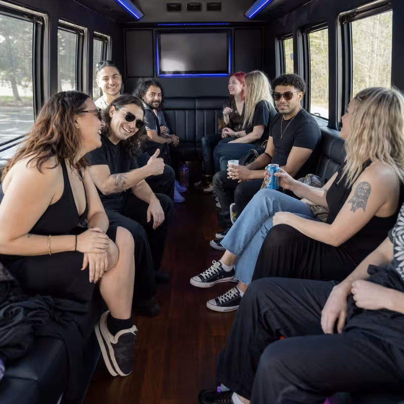 Group boarding a white charter bus for Concert Transportation transportation in Myrtle Beach