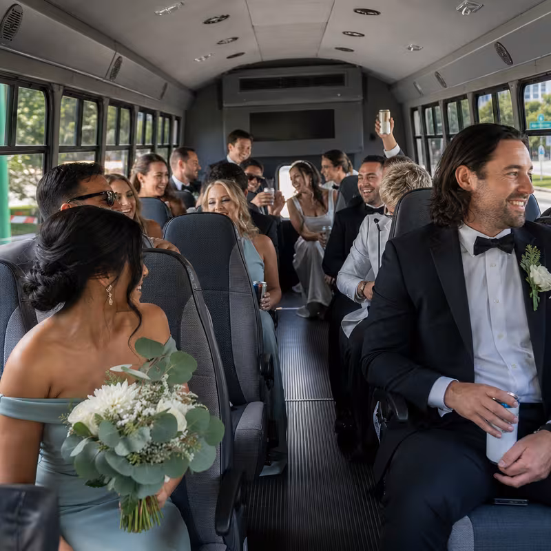 Group boarding a white charter bus for Wedding Transportation transportation in Myrtle Beach